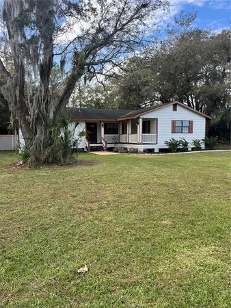 a front view of house with yard and trees