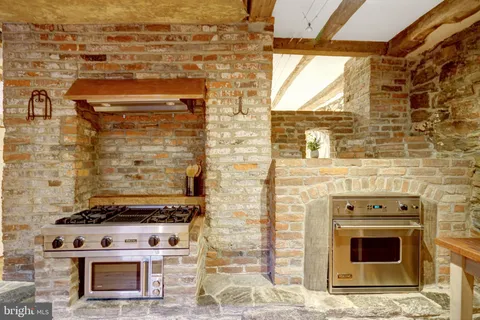a stove top oven sitting inside of a kitchen