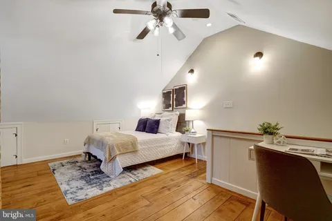 a room with a bed and a chandelier