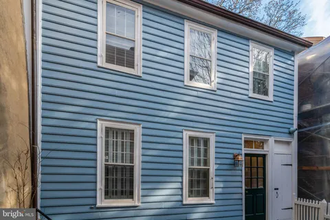 a view of a house that has a large window and door