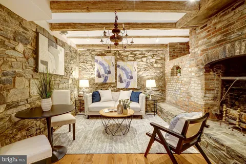 a living room with fireplace and a table