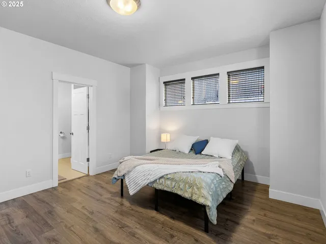 a bed sitting in a bedroom next to a window