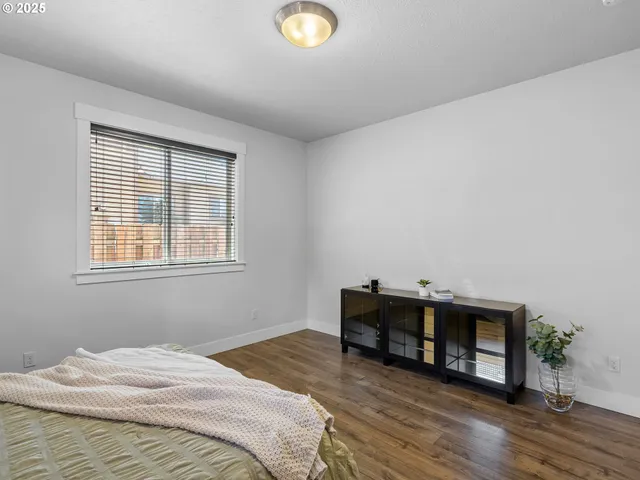 a bedroom with bed and a window