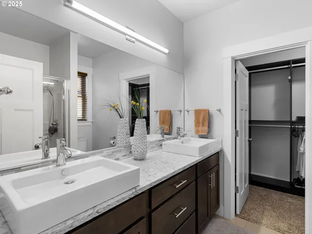 a bathroom with a double vanity sink mirror and double