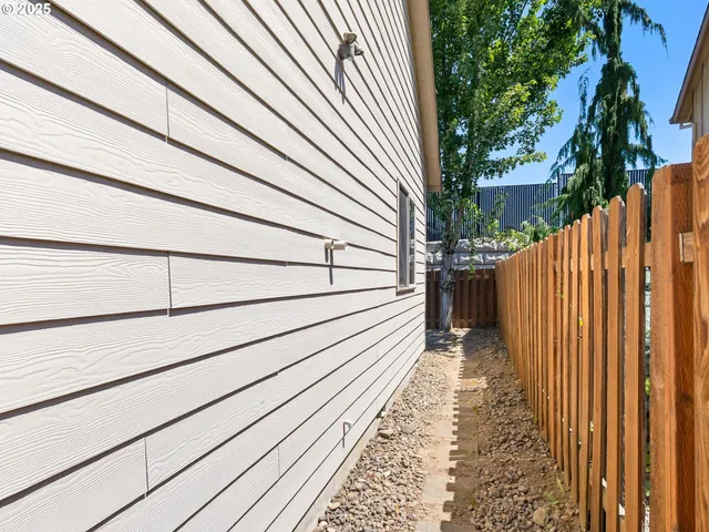 a view of a house with a wooden fence
