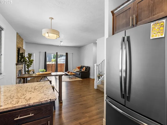 a kitchen with stainless steel appliances granite countertop a refrigerator and microwave