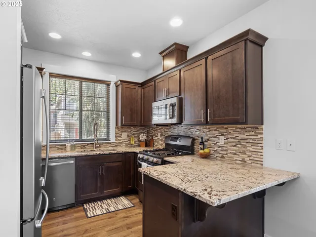a kitchen with a sink stove and cabinets