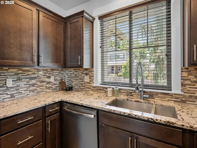 a kitchen with granite countertop a sink and a window