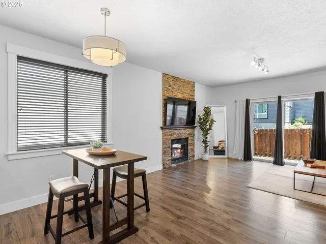a view of a livingroom with furniture a flat screen tv and wooden floor