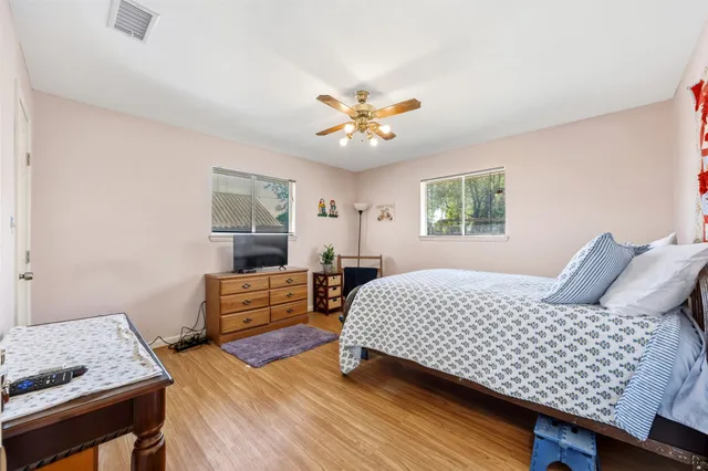 a bedroom with a bed and a dresser in it