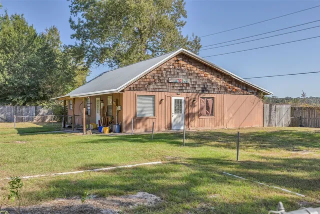 a view of a house with a yard and sitting area