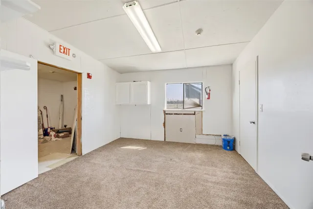 a view of kitchen with white cabinets