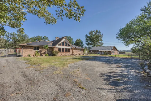 a view of house with outdoor space and sitting area
