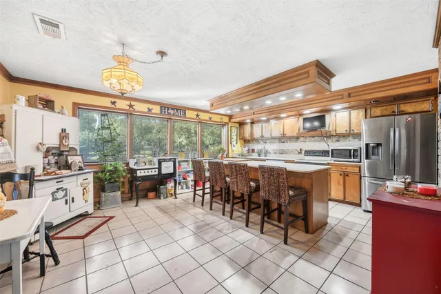 a open kitchen with a sink dining table and chairs