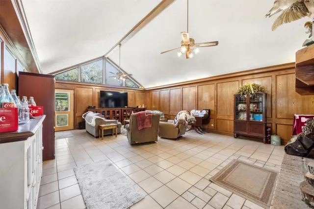 a living room with furniture a couch and potted plant