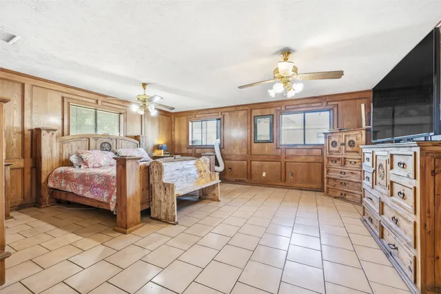 a bedroom with furniture and a chandelier
