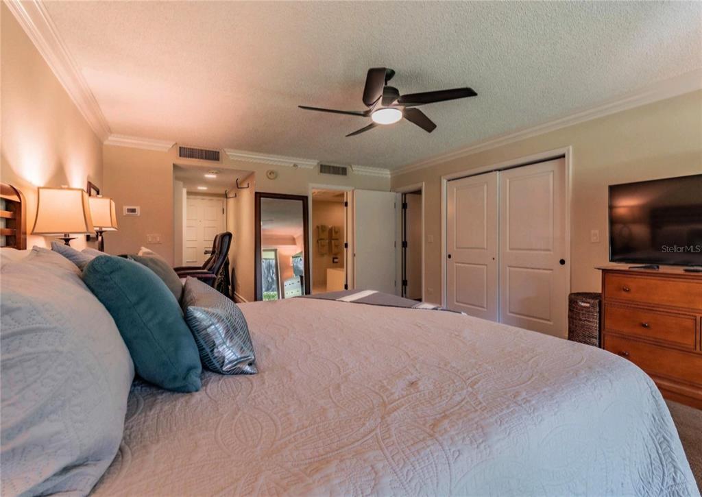 36750 Highway 19, Unit 82011 Palm Harbor, FL 34684 - Photo 11 of 15 a bedroom with a large bed and a flat tv screen on dresser