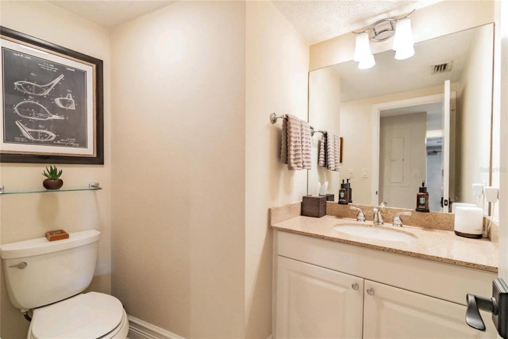 36750 Highway 19, Unit 82011 Palm Harbor, FL 34684 - Photo 13 of 15 a bathroom with a toilet a sink and mirror