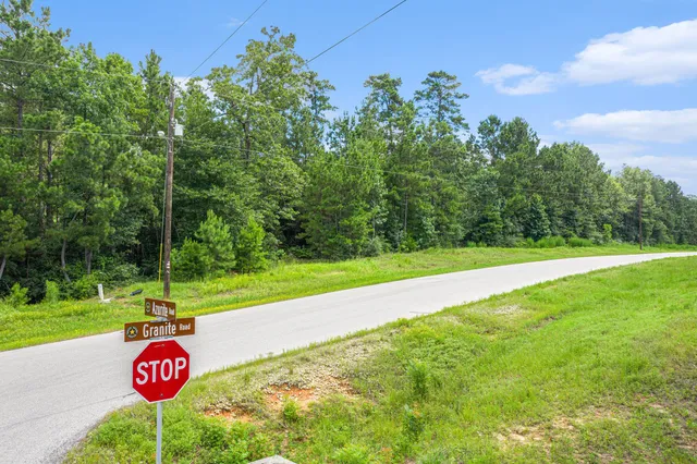 a view of a street with a yard
