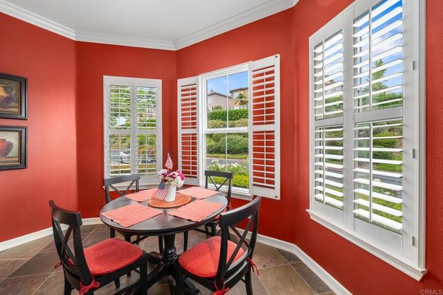 a view of a city with flower plants and large trees