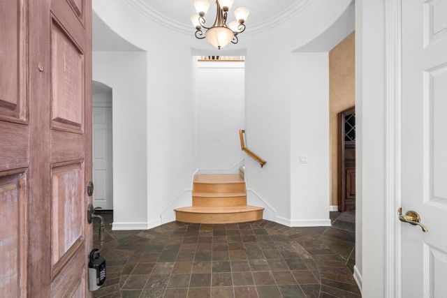 a dining room with furniture a chandelier and wooden floor