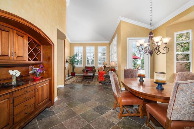a living room with furniture a fireplace with a flat screen tv