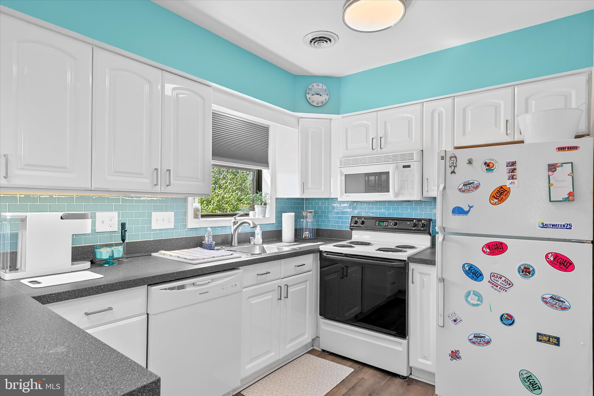 132 Jamestown Road, Unit 601 Ocean City, MD 21842 - Photo 11 of 37 a kitchen with stainless steel appliances granite countertop a sink a stove a refrigerator and white cabinets