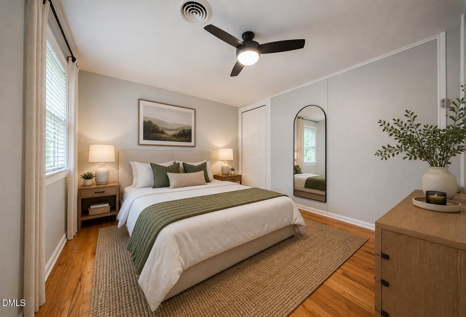 967 St Marys Street Raleigh, NC 27605 - Photo 24 of 34 a spacious bedroom with a bed and a potted plant