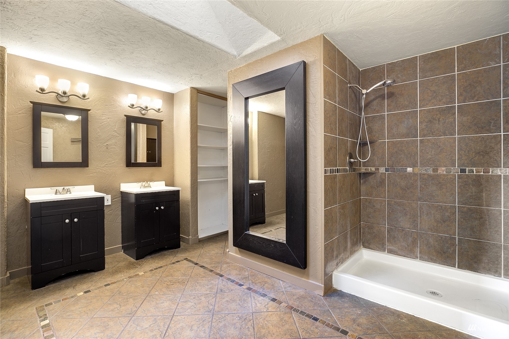 19027 Nutmeg Street Southwest Rochester, WA 98579 - Photo 8 of 22 a spacious bathroom with a shower a sink and mirror