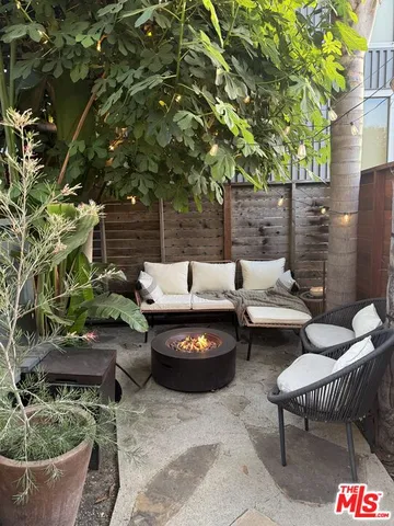 a view of a patio with couple of chairs and a fire pit