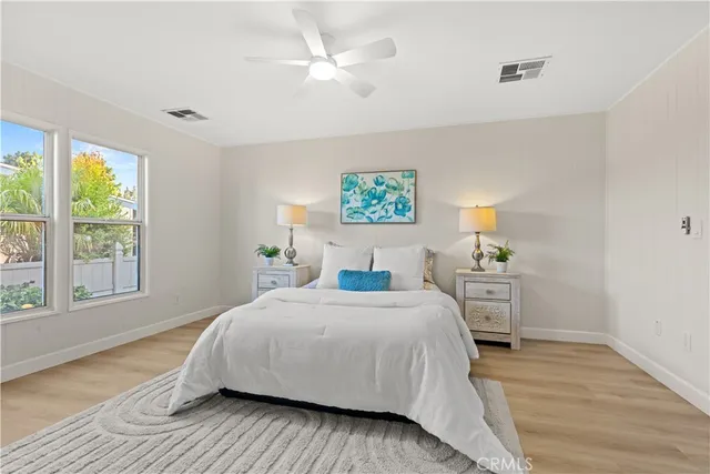 a bedroom with bed and a chandelier