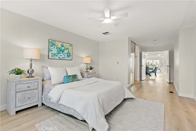 a bathroom with a granite countertop sink a mirror a vanity and a bathtub