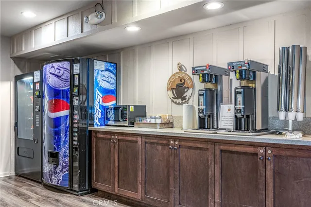 a room with stainless steel appliances lots of wooden furniture