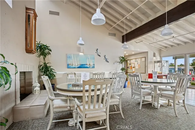 a dining room with furniture a chandelier and window