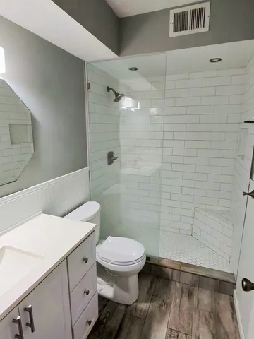a bathroom with a toilet a sink and shower