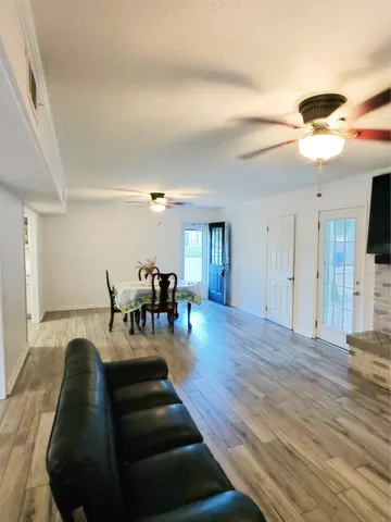 a living room with furniture and a wooden floor