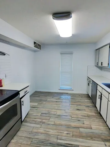 a view of a kitchen with a sink and cabinets