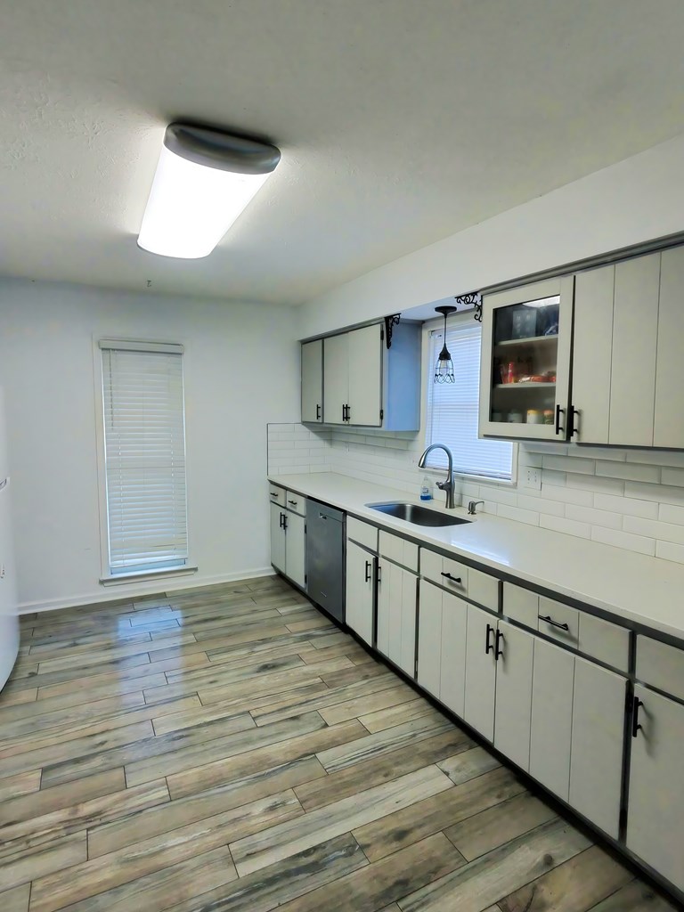 4715 Teak Drive Columbus, GA 31909 - Photo 10 of 19 a large kitchen with stainless steel appliances granite countertop a sink and cabinets with wooden floor