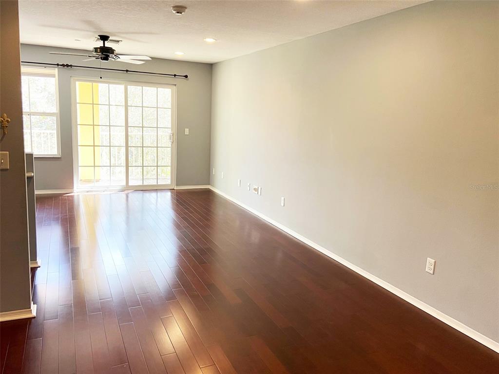 8946 White Sage Loop Lakewood Ranch, FL 34202 - Photo 4 of 36 an empty room with wooden floor and windows