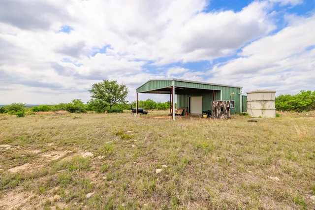 a front view of house with yard and lake view