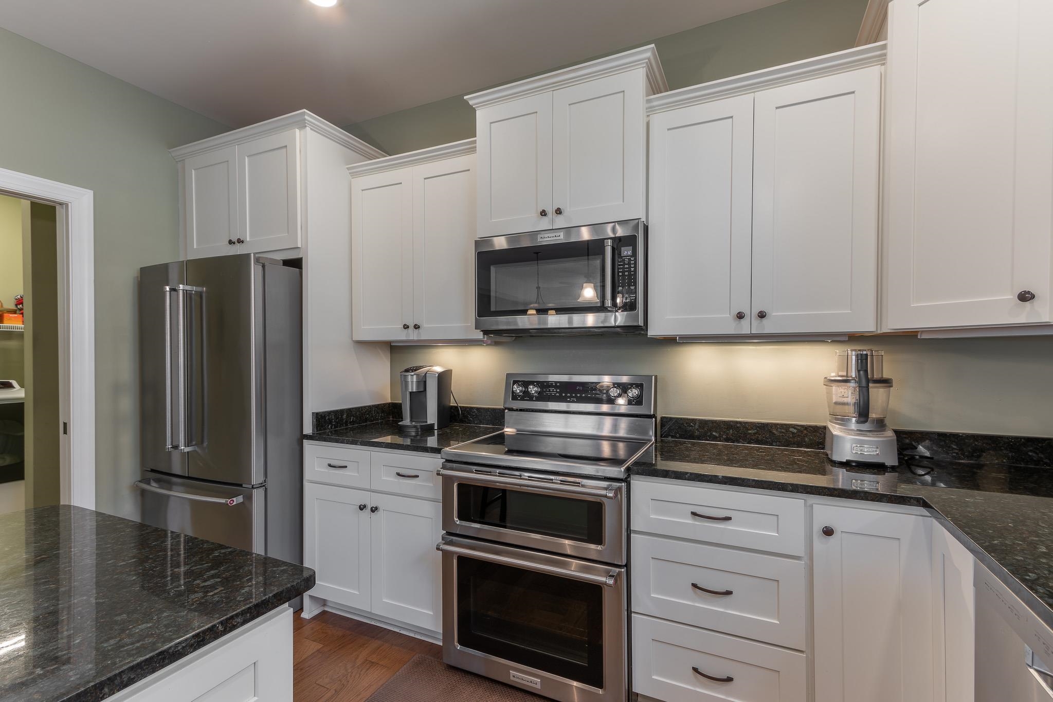 1685 Bald Eagle Circle Harrisonburg, VA 22801 - Photo 21 of 53 a kitchen with granite countertop a refrigerator stove and microwave
