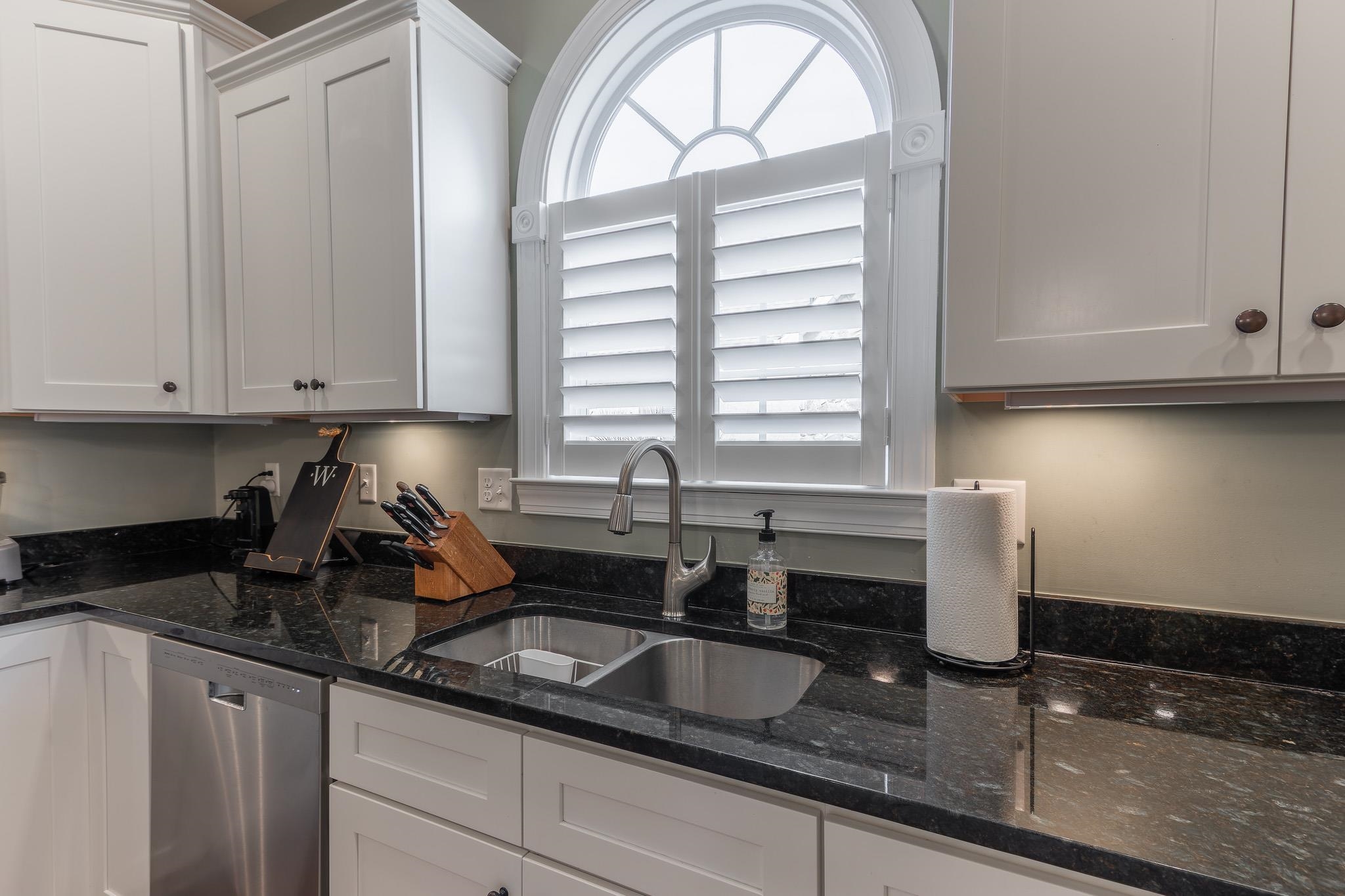1685 Bald Eagle Circle Harrisonburg, VA 22801 - Photo 23 of 53 a kitchen with granite countertop a sink a window and cabinets