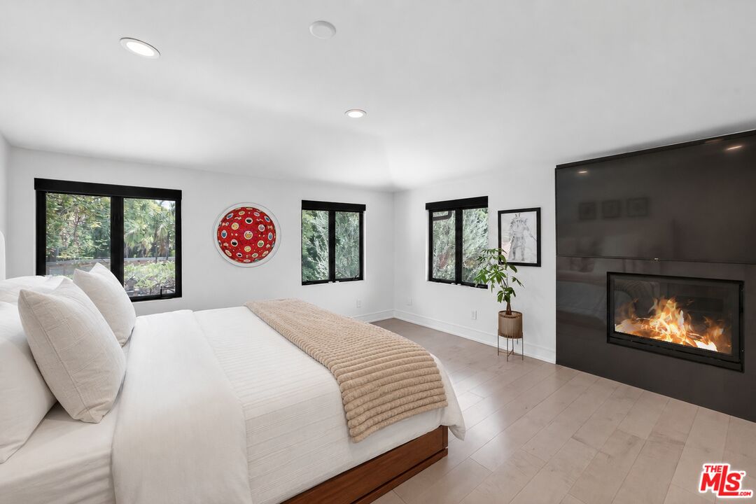 760 South San Rafael Avenue Pasadena, CA 91105 - Photo 28 of 45 a spacious bedroom with a bed and a fireplace