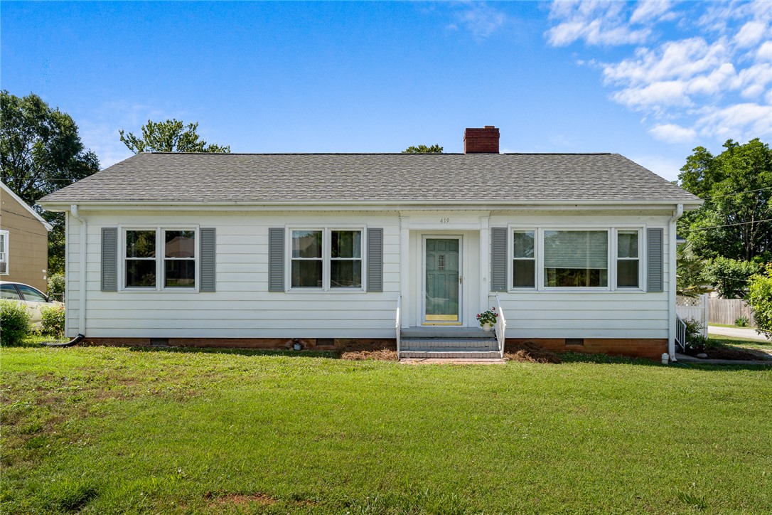 419 Whitehall Road Anderson, SC 29625 - Photo 1 of 28 A classic facade with contrasting shutters and a vibrant green lawn creates a welcoming presence.