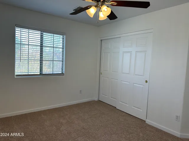 an empty room with closet area