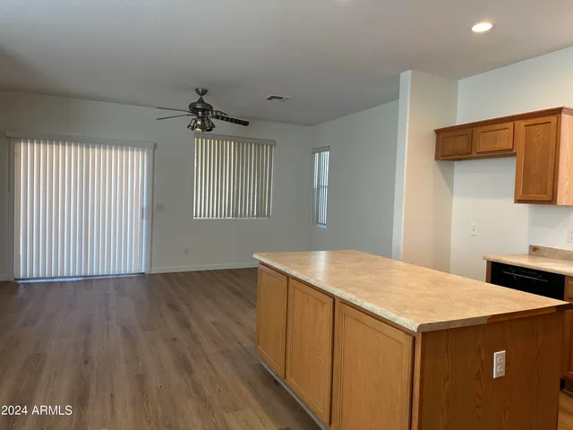 a kitchen with a wooden floor and window