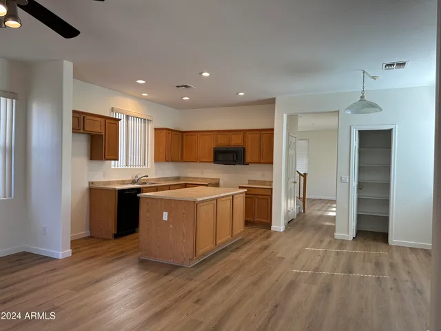 a large kitchen with stainless steel appliances kitchen island granite countertop a stove and a sink