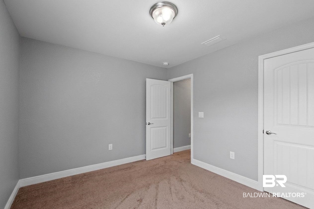 22076 Garland Loop Silverhill, AL 36576 - Photo 5 of 27 Carpeted interior space featuring light gray walls, white trim, and a white ceiling