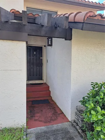 a view of front door of a house with stairs