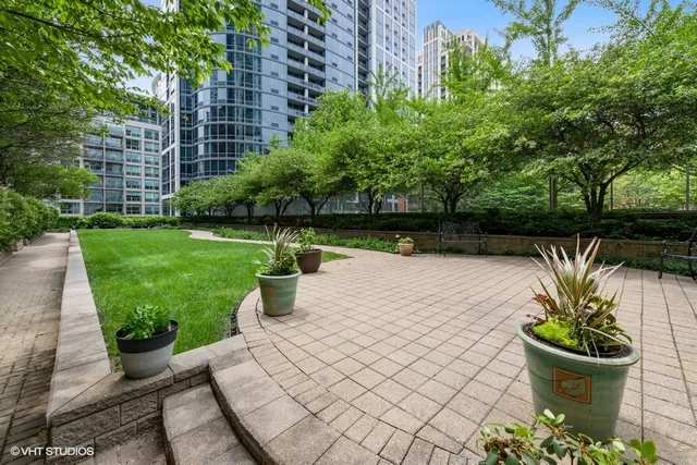 a view of a backyard with plants and a patio